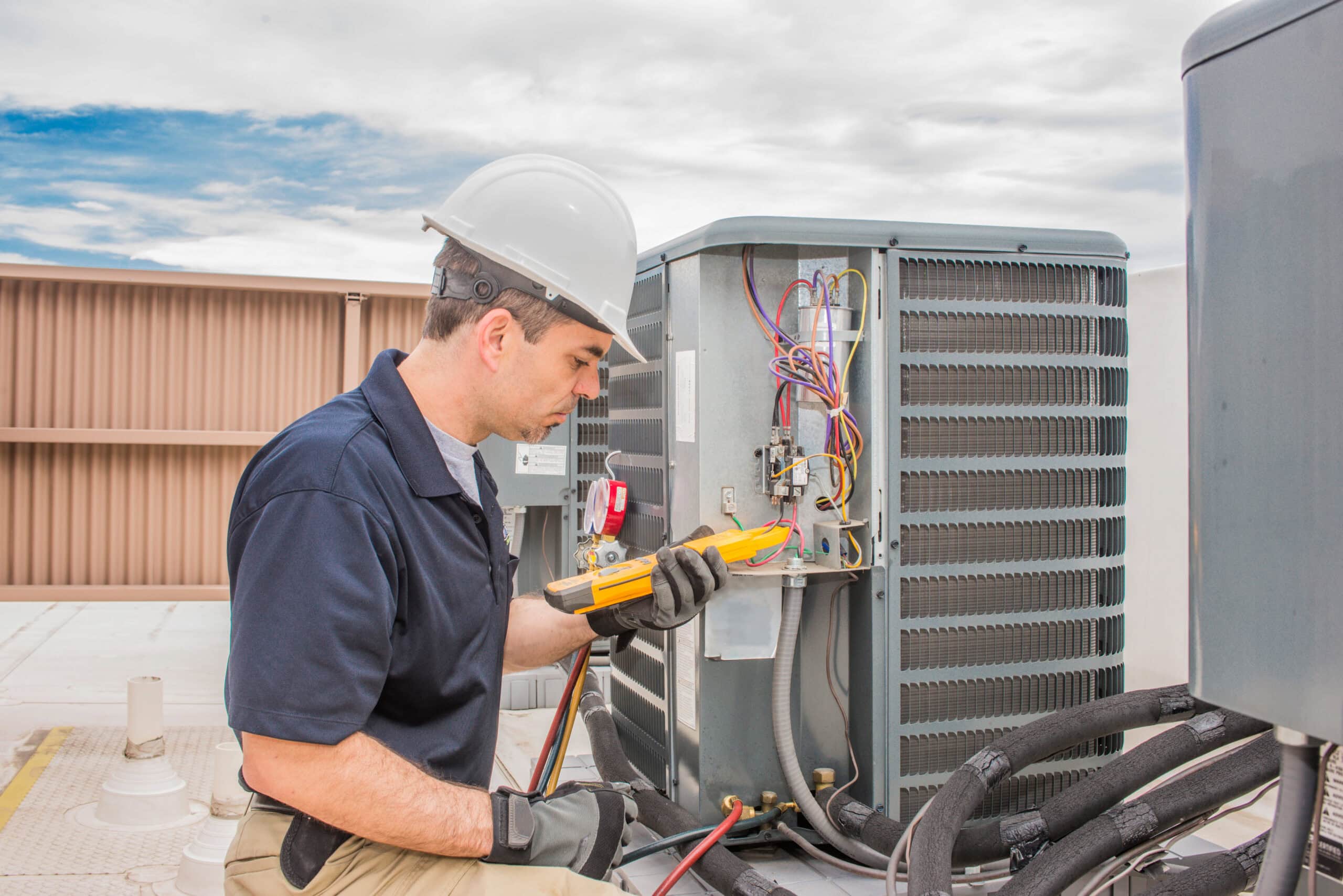 Trained,Hvac,Technician,Holding,A,Voltage,Meter,,Performing,Preventative,Maintenance